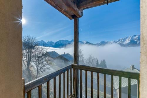 a room with a balcony with a view of snow covered mountains at Chalet le Regain in Villard-Reculas