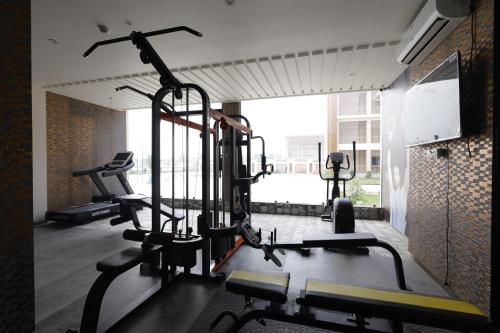 a gym with several tread machines in a room at Nirvana Grand Hotel & Resort in Gaya