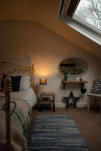 a bedroom with a bed and a large window at Hot tub - Number 37 in Llansantffraid Glan Conwy