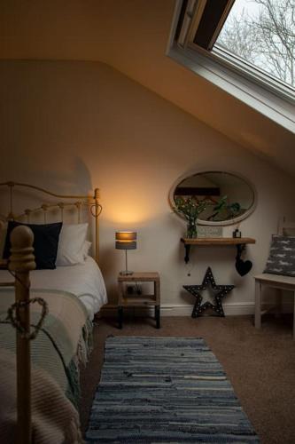 a bedroom with a bed and a large window at Hot tub - Number 37 in Llansantffraid Glan Conwy
