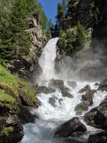 a waterfall on a river with rocks and trees at Casa vacanze Heidi e Peter Val di Rabbi in Rabbi