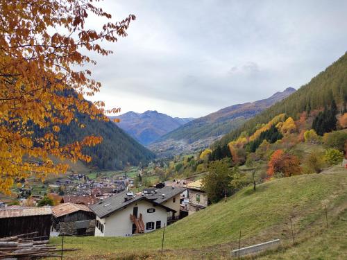 a town on a hill with mountains in the background at Casa vacanze Heidi e Peter Val di Rabbi in Rabbi