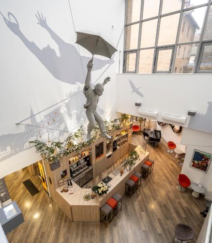 a restaurant with a statue of a man holding an umbrella at Ciarus in Strasbourg