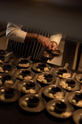 a man standing in front of a bunch of cupcakes at @before sunset in Cesme