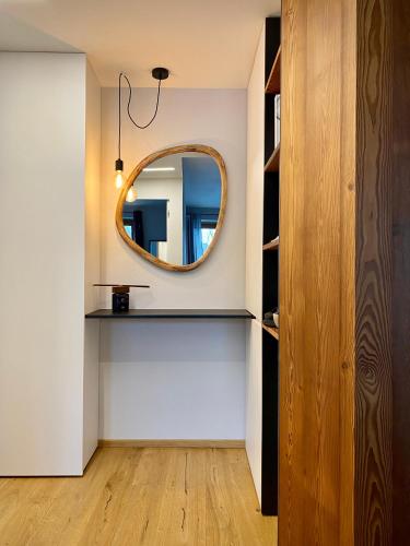 a room with a mirror and a shelf at La Primula in Pragelato