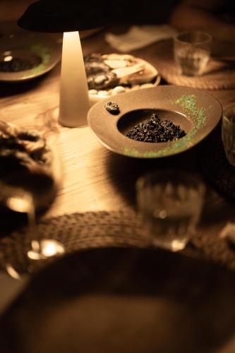 a wooden table with a plate of food on it at @before sunset in Cesme