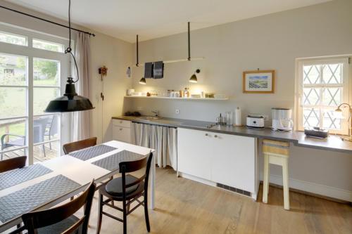 a kitchen with a table and a table and chairs at Gasthaus Schwanen & Villa Pfarrhus in Stühlingen