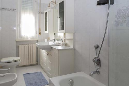 a bathroom with a sink and a toilet and a shower at Casa Enrica in Arenzano