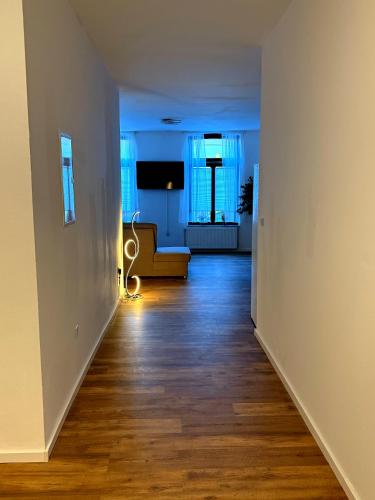 an empty hallway with a couch in a living room at Logis-Apartment in Bremen