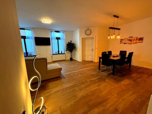 a living room with a table and a dining room at Logis-Apartment in Bremen