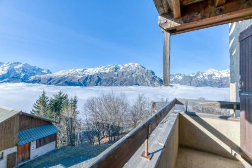 a view of mountains from the balcony of a house at Chalet le Regain in Villard-Reculas