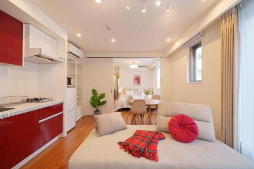 a living room with a couch and a kitchen at Space Roppongi in Tokyo