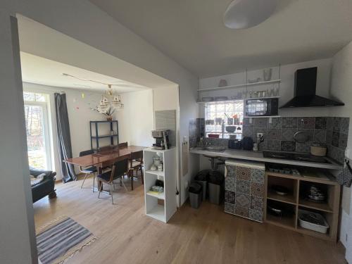 a kitchen and dining room with a table and a kitchen and a room at Hačaperka domeček in Horní Město
