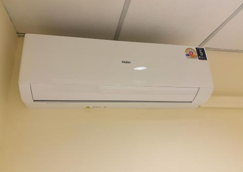 a white system is hanging from a ceiling at Apamet Hotel Sukhumvit 55 in Khlong Toei