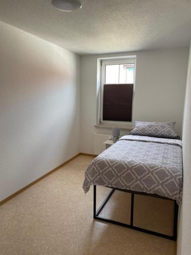 a bedroom with a bed and a window at Ferienwohnung Stadtblick in Arneburg