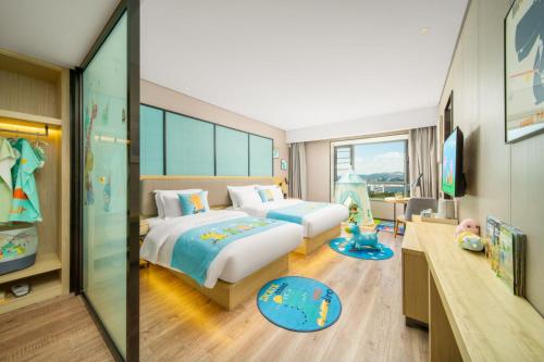 a hotel room with two beds and a tv at Echarm Hotel Kunming Changshui International Airport in Kunming