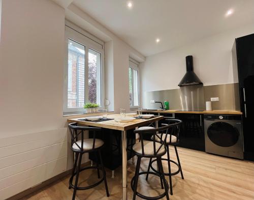 une cuisine avec un îlot et des tabourets de bar dans l'établissement Le refuge - Central - Confortable - Parking Public, à Arras