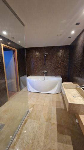 a large bathroom with a tub and a sink at Vinni Sport & Spa hostel in Vinni