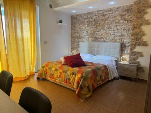 Ένα ή περισσότερα κρεβάτια σε δωμάτιο στο B&B Palazzo del Toro