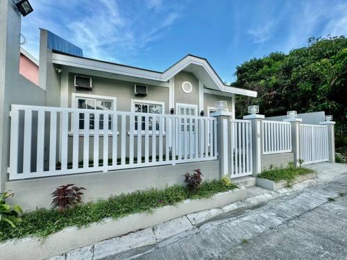 a white fence in front of a house at Casa Leonardo-Bel Air 4 in Santa Rosa