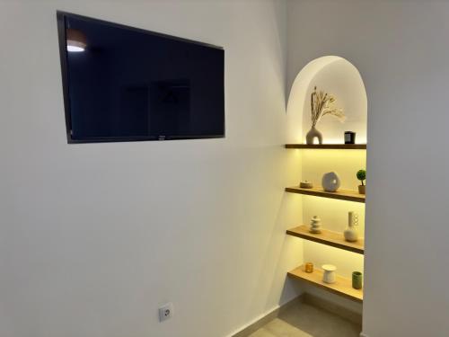 a living room with a tv on the wall at Villa Cecilia Luxury Stay in Kastoria