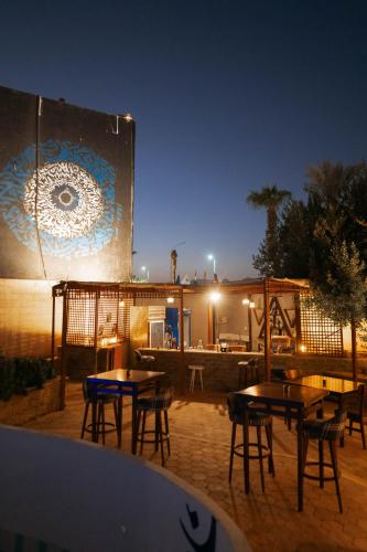 a group of tables and chairs in front of a building at El Khan Sharm Hotel in Sharm El Sheikh