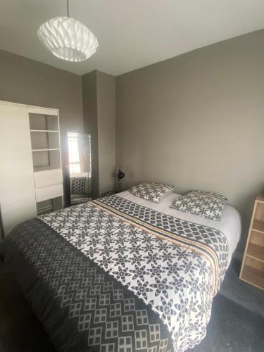 a bedroom with a large bed with two pillows at Maison proche de vichy in Saint-Rémy-en-Rollat
