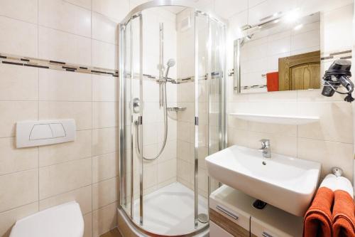 a bathroom with a shower and a sink at Gästehaus Wolfgang Chiemsee -1- in Ruhpolding