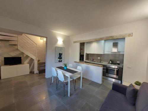 a kitchen and a living room with a table and chairs at Casa Vacanze Francesco in Florence