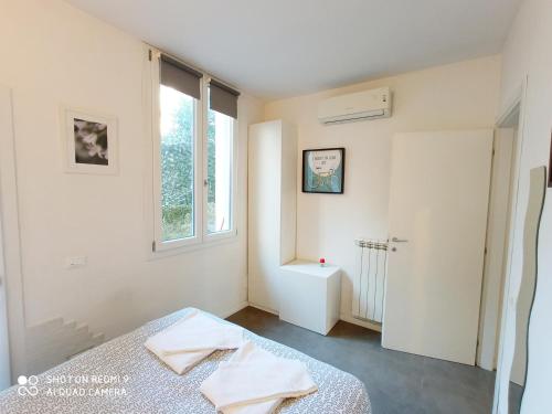 a white room with a bed and a window at Casa Vacanze Francesco in Florence