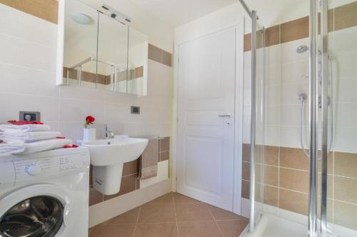 a bathroom with a washing machine and a sink at Monte Rosa Panorama in Staval