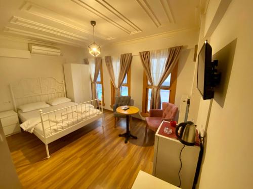 a small living room with a bed and a table at Konak Akaretler Suit in Istanbul