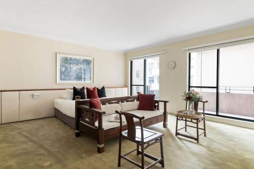 a living room with a couch and a table at Stylish & Cozy 4BR Retreat with FREE Parking in Melbourne