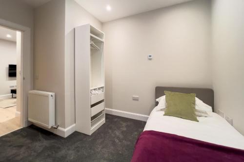 a small bedroom with a bed and a closet at 13 Crails Lane in St. Andrews