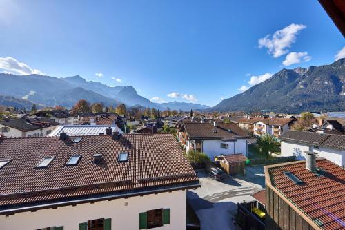 a view of a town with mountains in the background at Hotel Drei Mohren in Garmisch-Partenkirchen