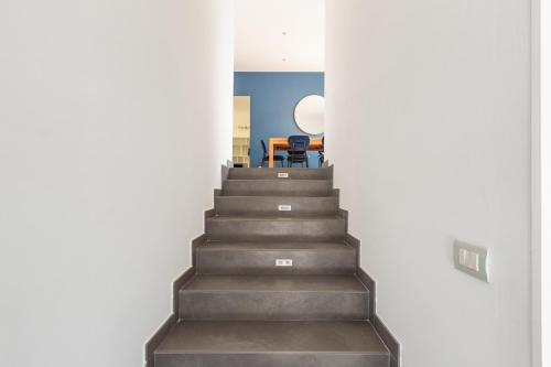 a stairway leading up to a room with a table at Villa Acquadimare - Pool Terrace Jacuzzi in Lecce