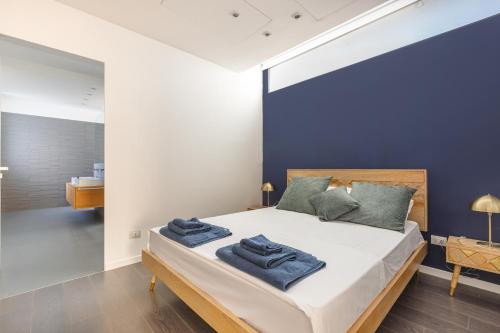 a bedroom with a large bed with blue walls at Villa Acquadimare - Pool Terrace Jacuzzi in Lecce