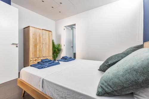 a bedroom with a bed with blue towels on it at Villa Acquadimare - Pool Terrace Jacuzzi in Lecce