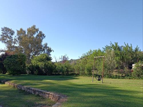 a park with a swing set in the grass at Alwynskop Guest house in Alwyns Kop