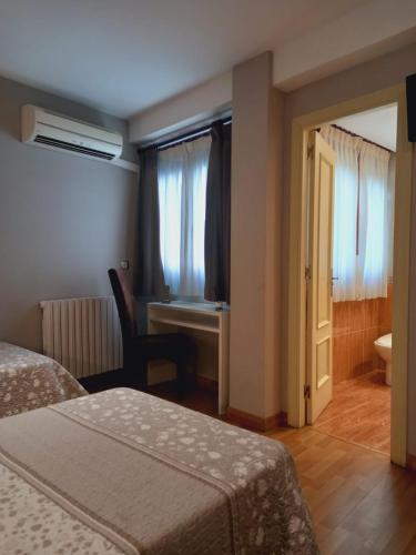 Ένα ή περισσότερα κρεβάτια σε δωμάτιο στο Hotel El Acebo
