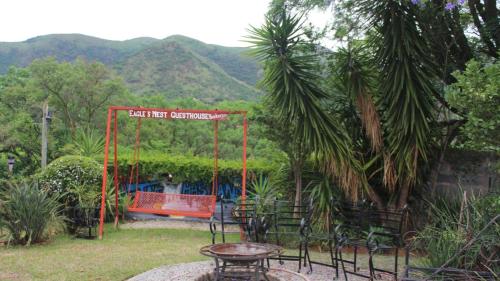 a park with a swing and a table and chairs at Eagle's Nest in Barberton