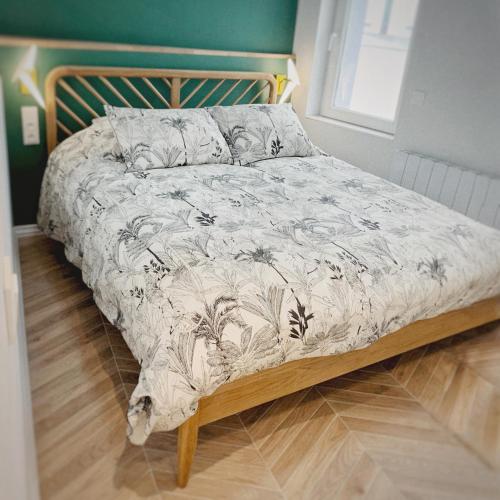 - un lit dans une chambre avec une tête de lit en bois dans l'établissement Tiny house avec terrasse privée, à Mulhouse