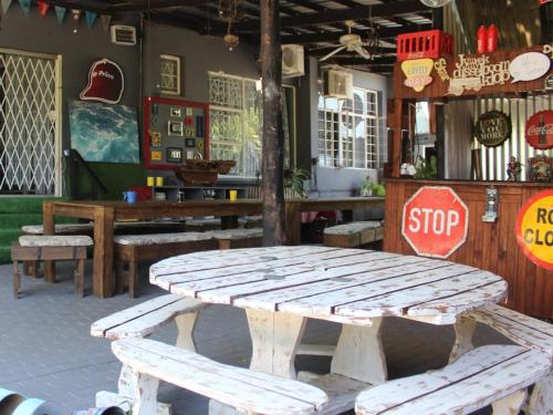 a wooden picnic table in a restaurant with a stop sign at Eagle's Nest in Barberton