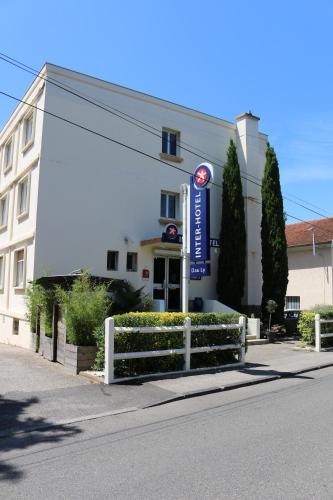 a white building with a sign in front of it at The Originals City, Hôtel Dau Ly, Lyon Est in Bron