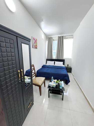 a bedroom with a bed and a chair and a table at Sea View Stay Abu Dhabi in Abu Dhabi