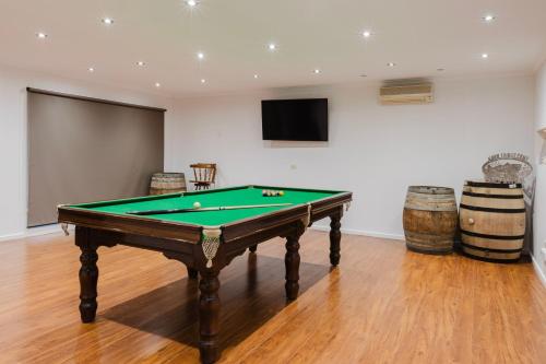 a pool table in a room with barrels at 123Chishlom in Wonthaggi