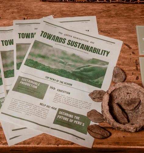 a table with a newspaper and a cookie on it at Ecolucerna Lodge Tambopata in Puerto Maldonado