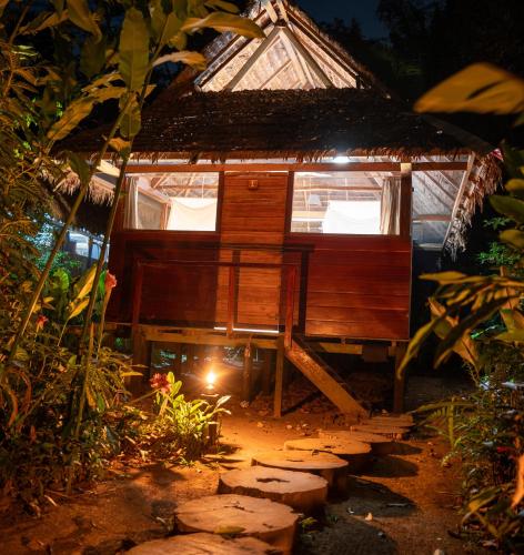 a tree house with a pathway leading up to it at Ecolucerna Lodge Tambopata in Puerto Maldonado