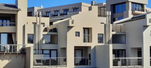 an image of an apartment building with balconies at Lakeside Apartment in Oubaai Golf Estate in George