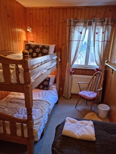 a bedroom with two bunk beds and a window at Chalet Taipan Verbier in Verbier